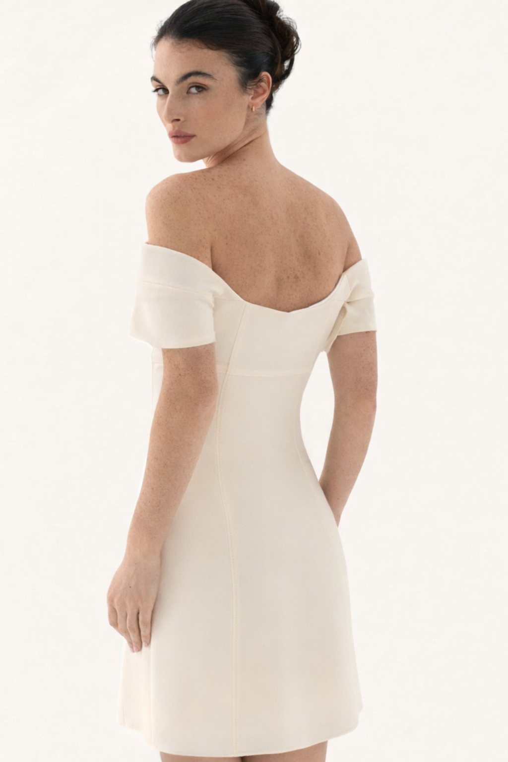 Back view of cream off shoulder mini dress
