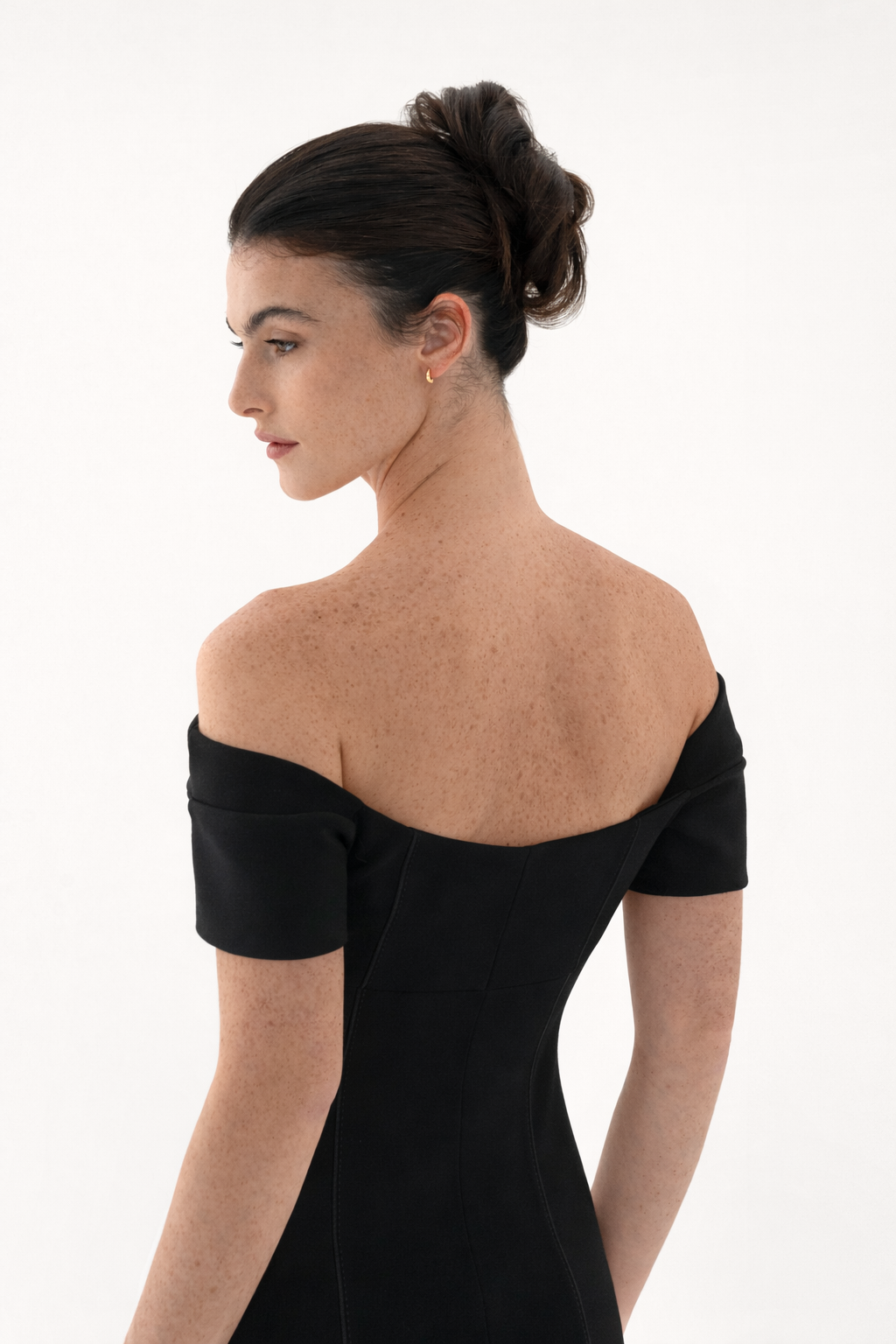 Back view of black off shoulder mini dress